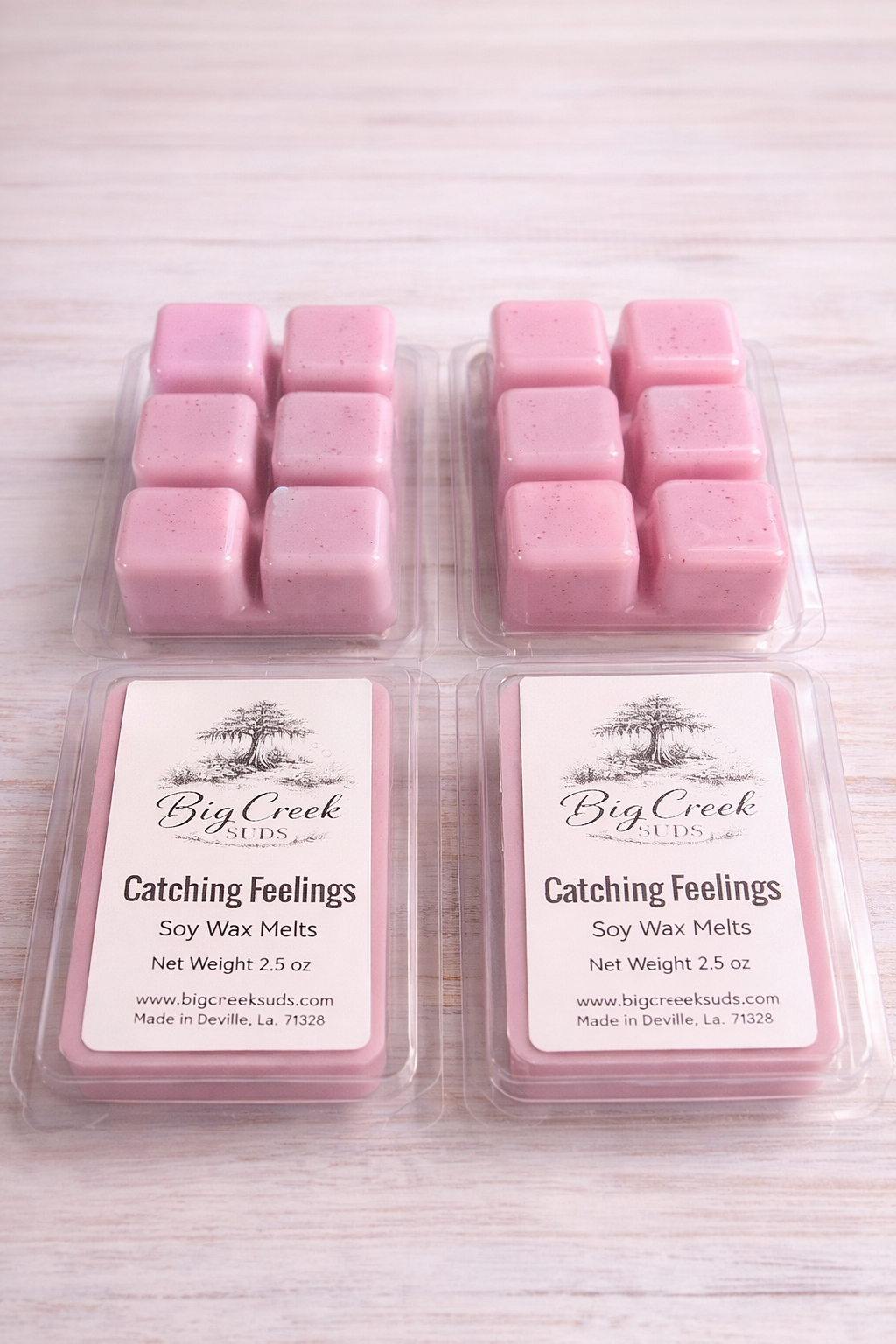 Pink soy wax melts in packaging with 'Big Creek' branding on a light wooden surface.